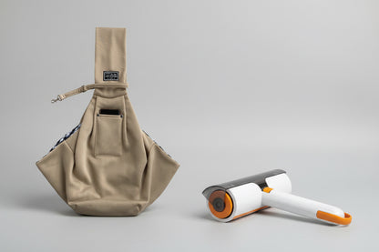 Beige bag and white hair removal roller on a striped background
