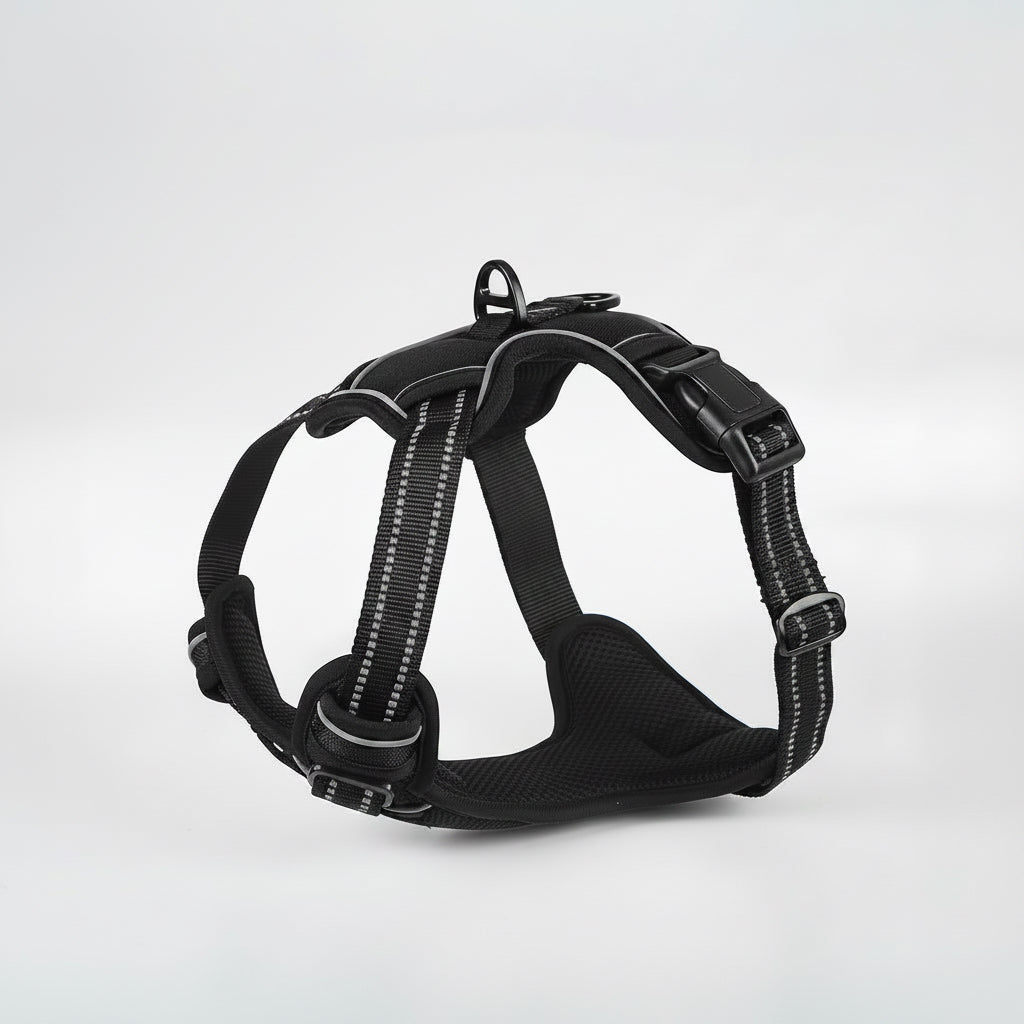Black dog harness with reflective stripes on a white background