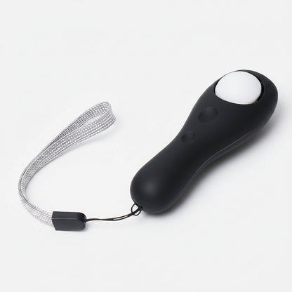 Black remote control with a white button on a white background