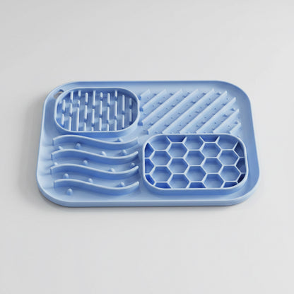 Blue silicone tray with textured sections on a white background