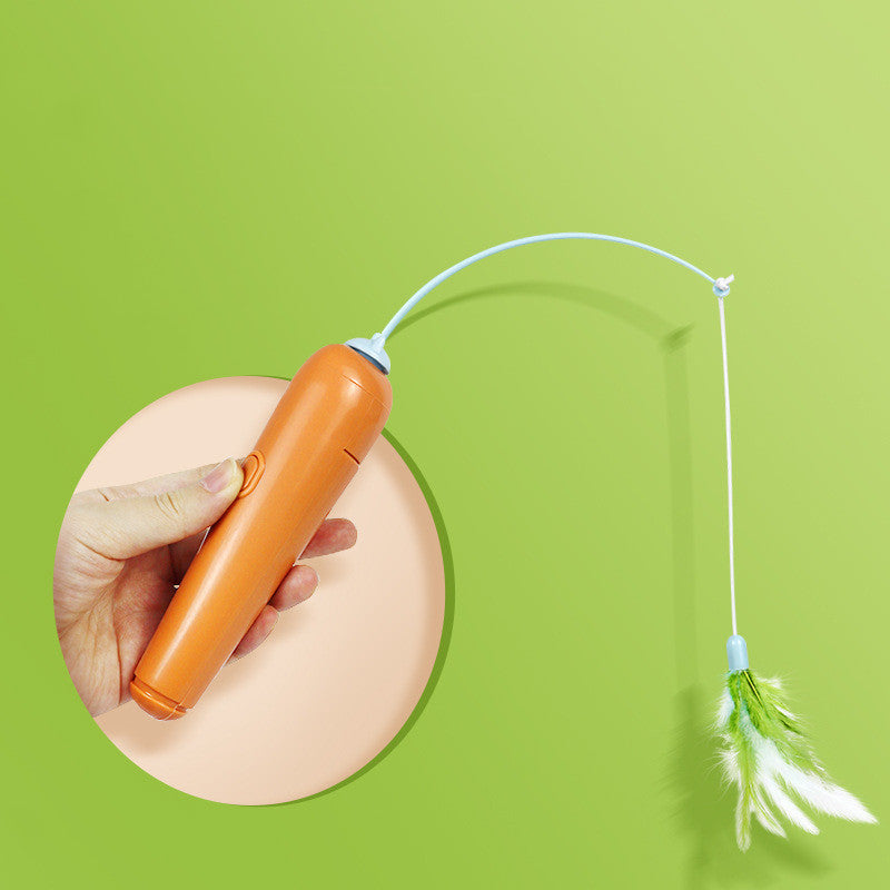 Orange electronic device with a string and feather attachment on a green background