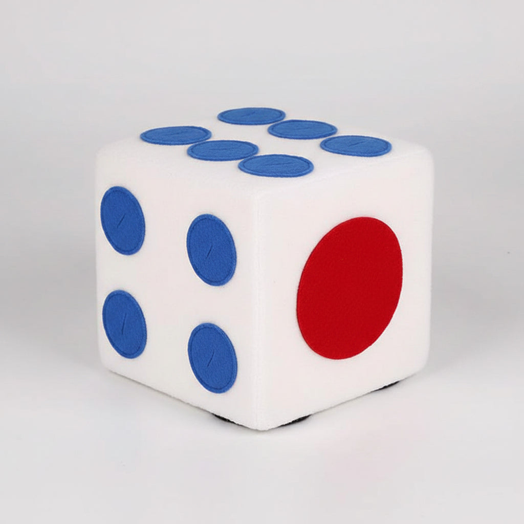 White die with blue, black, and red faces on a white background