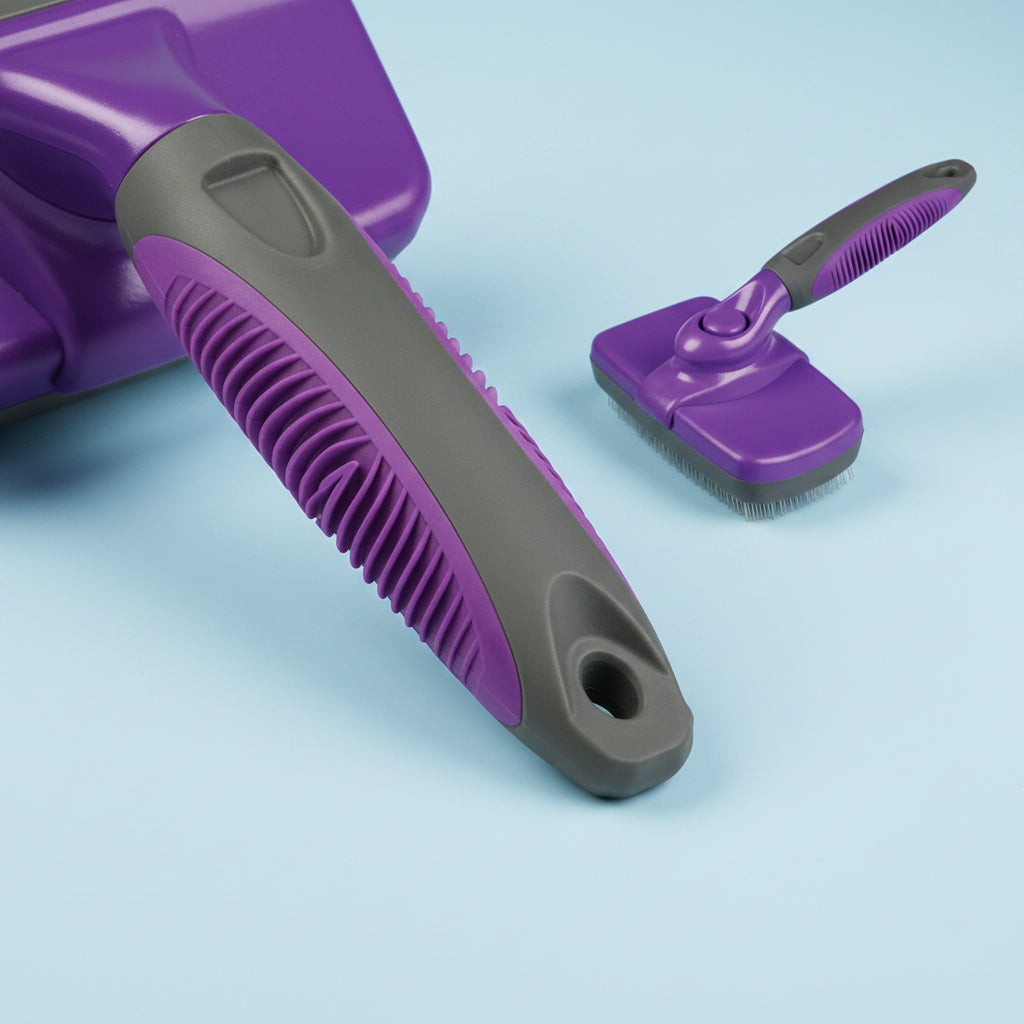 Purple and gray pet grooming brush on a white background