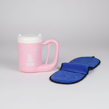 Pink mug with a blue paw print oven mat next to it.