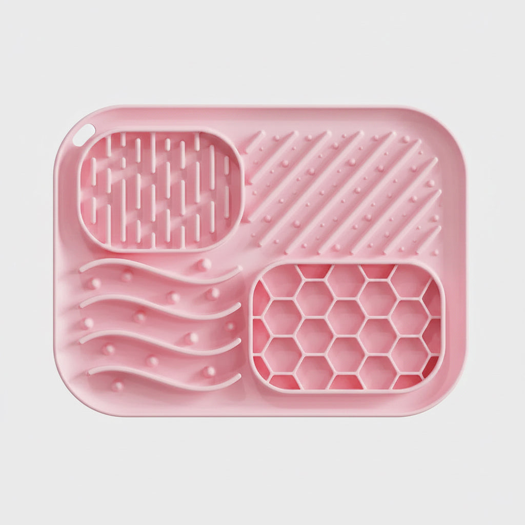 Pink silicone tray with textured sections on a white background