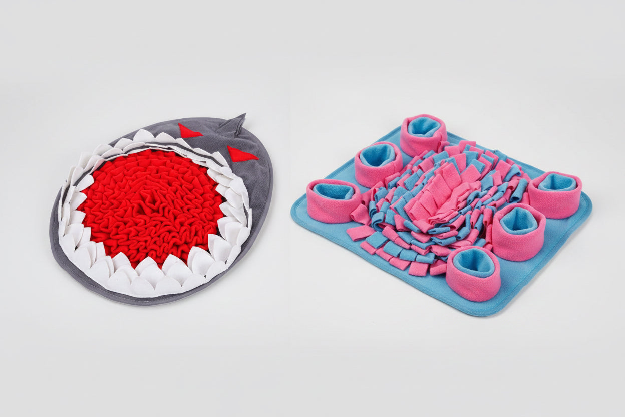 Two textured mats, one shark-shaped and one with pink and blue design, on a white background.
