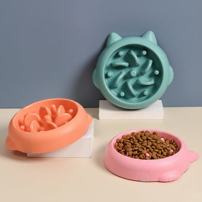 Three colorful pet bowls with textured surfaces on a neutral background