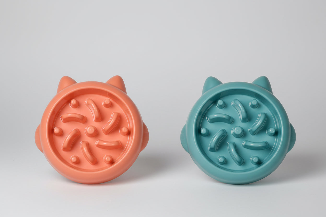 Two Bowls, one orange and one green, with textured surfaces on a white background.