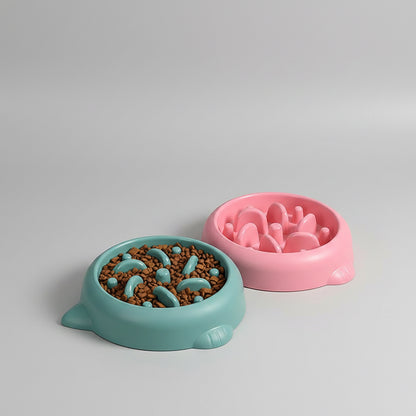 Green and pink slow feeder bowls with food