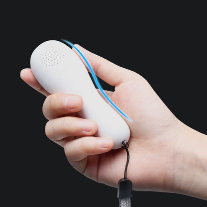 Hand holding a white electronic device with a blue strap against a black background